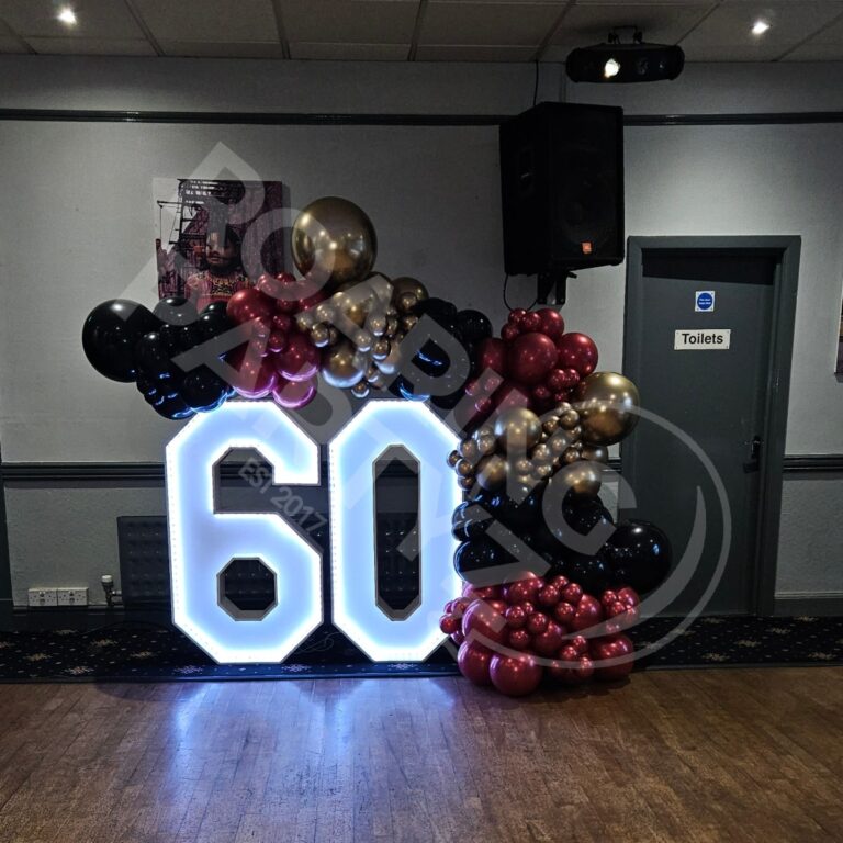 4ft Light up numbers 60 with a deluxe Balloon garland around at Aughton Institute in Merseyside